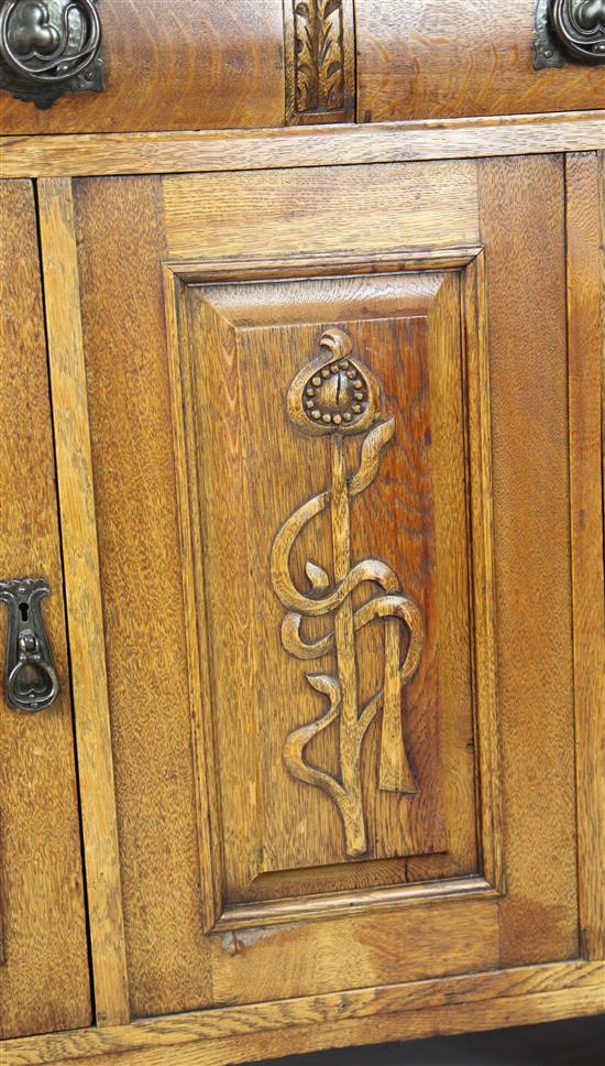 An Arts & Crafts carved oak sideboard with raised mirrored back, W. 5ft 8in. D. 1ft 11in. H. 6ft 4in.